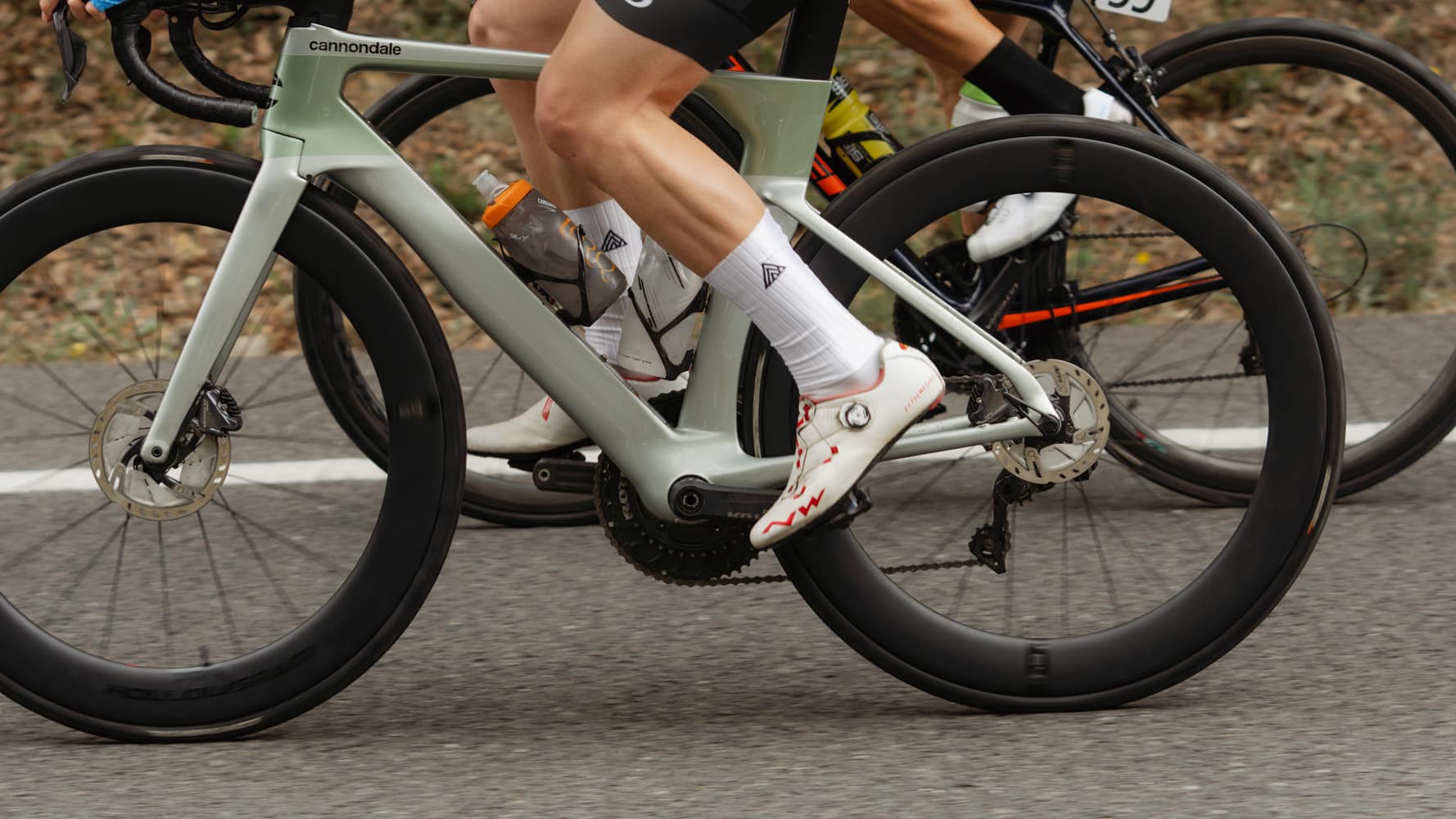 Wheels and legs of road cyclists riding together on the tarmac, Mallorca